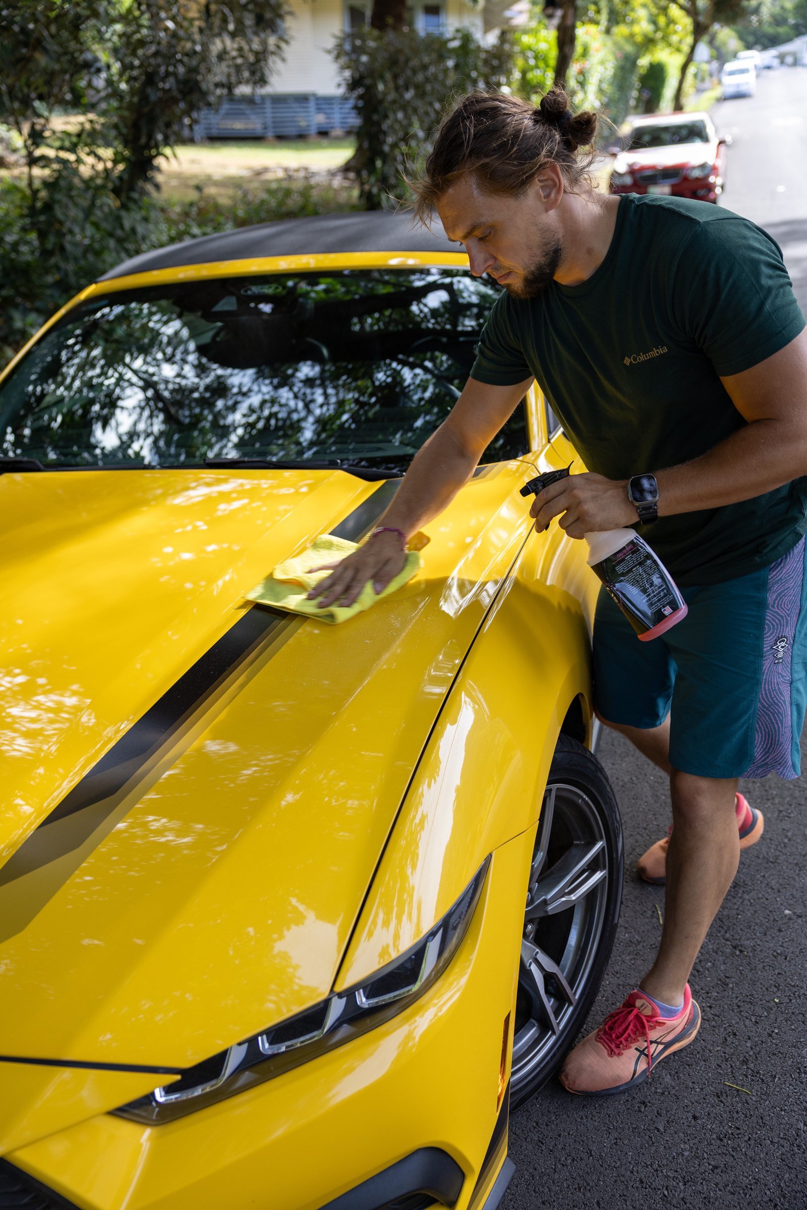 808 Car Shine detailer caring for a yellow sports car in Honolulu